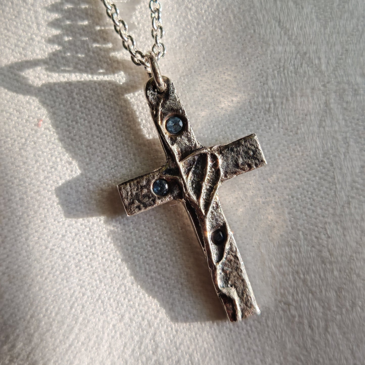 blue sapphires in cross pendant