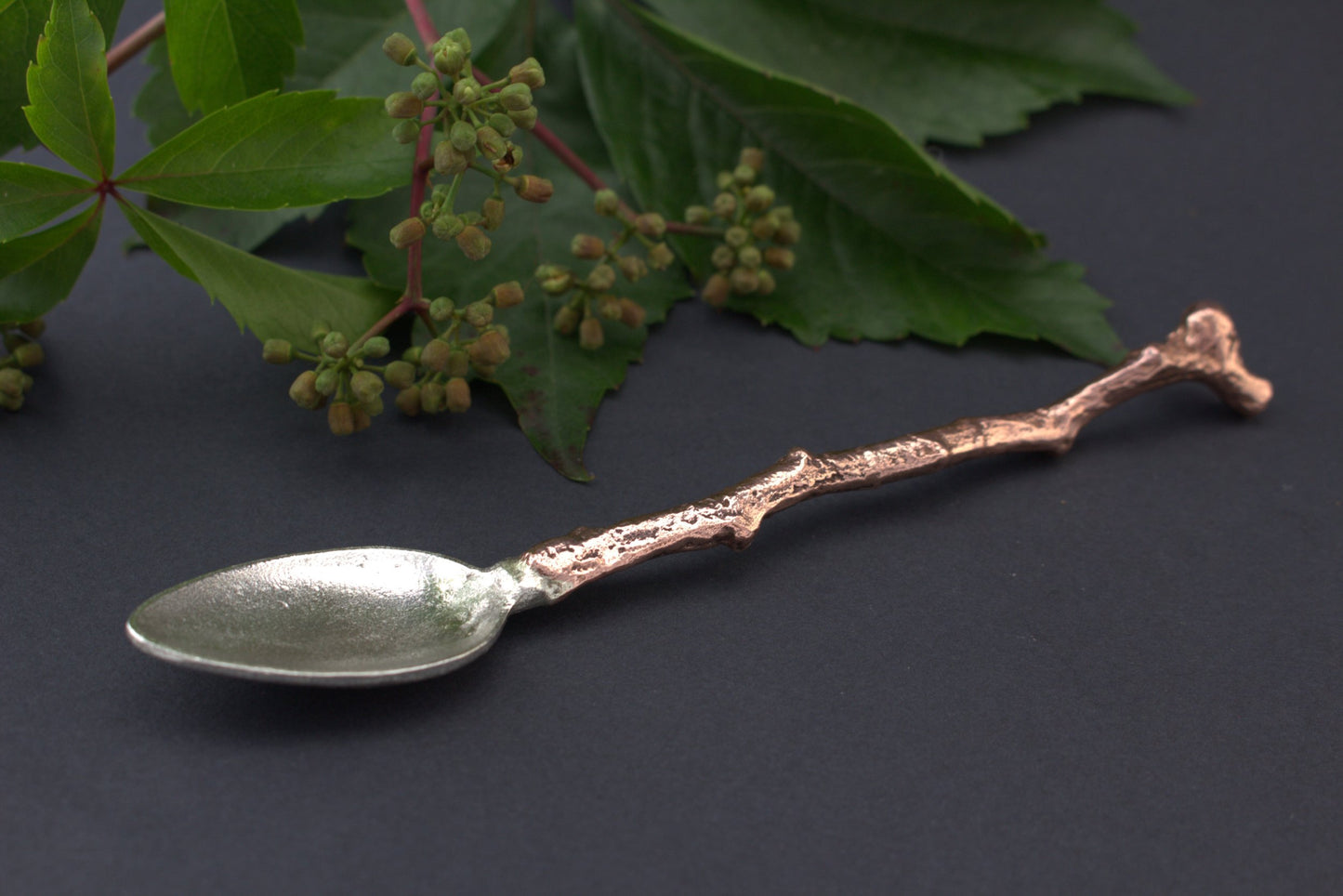 silver spoon with copper handle left