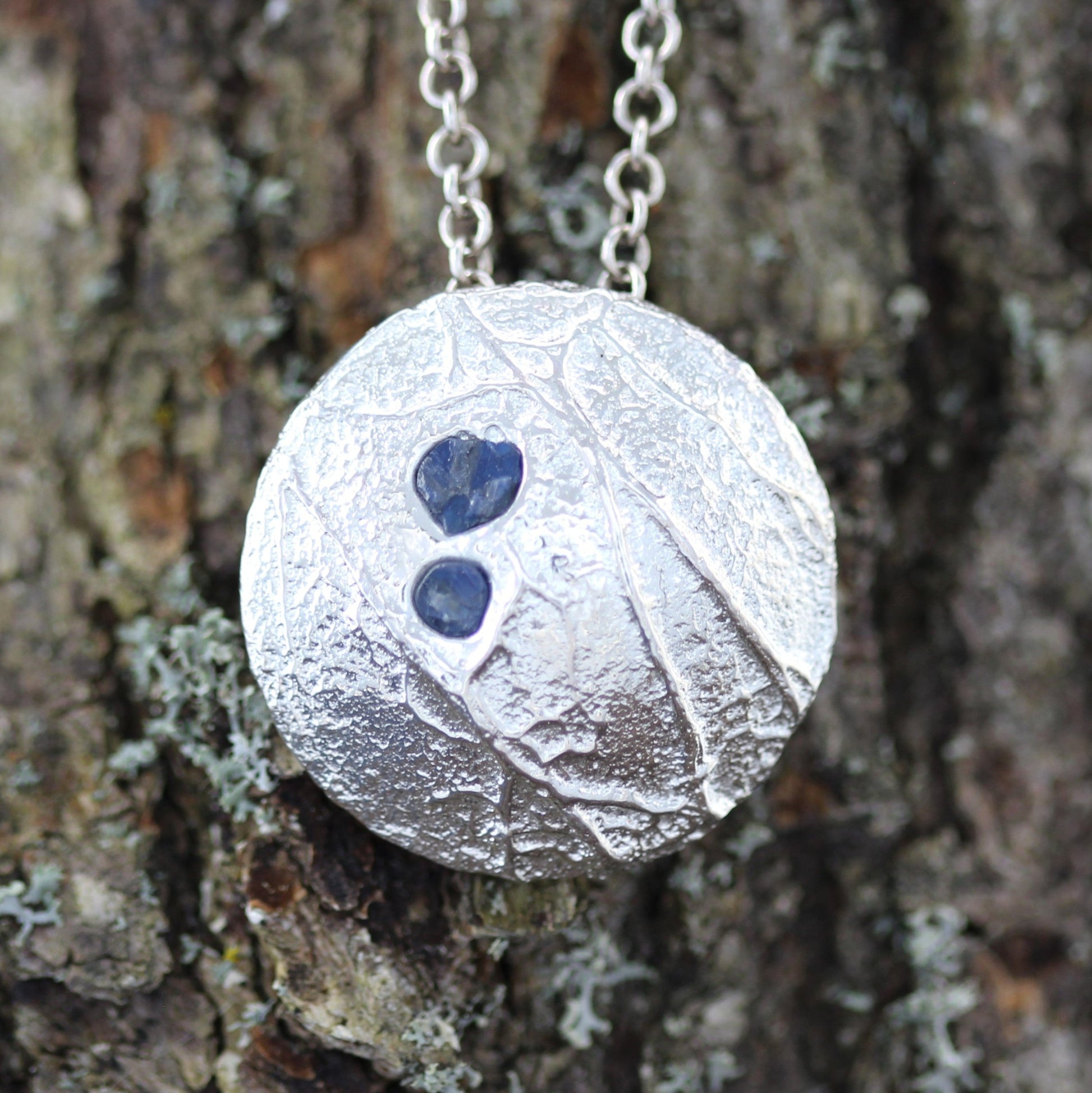 roots silver pendant with blue sapphires