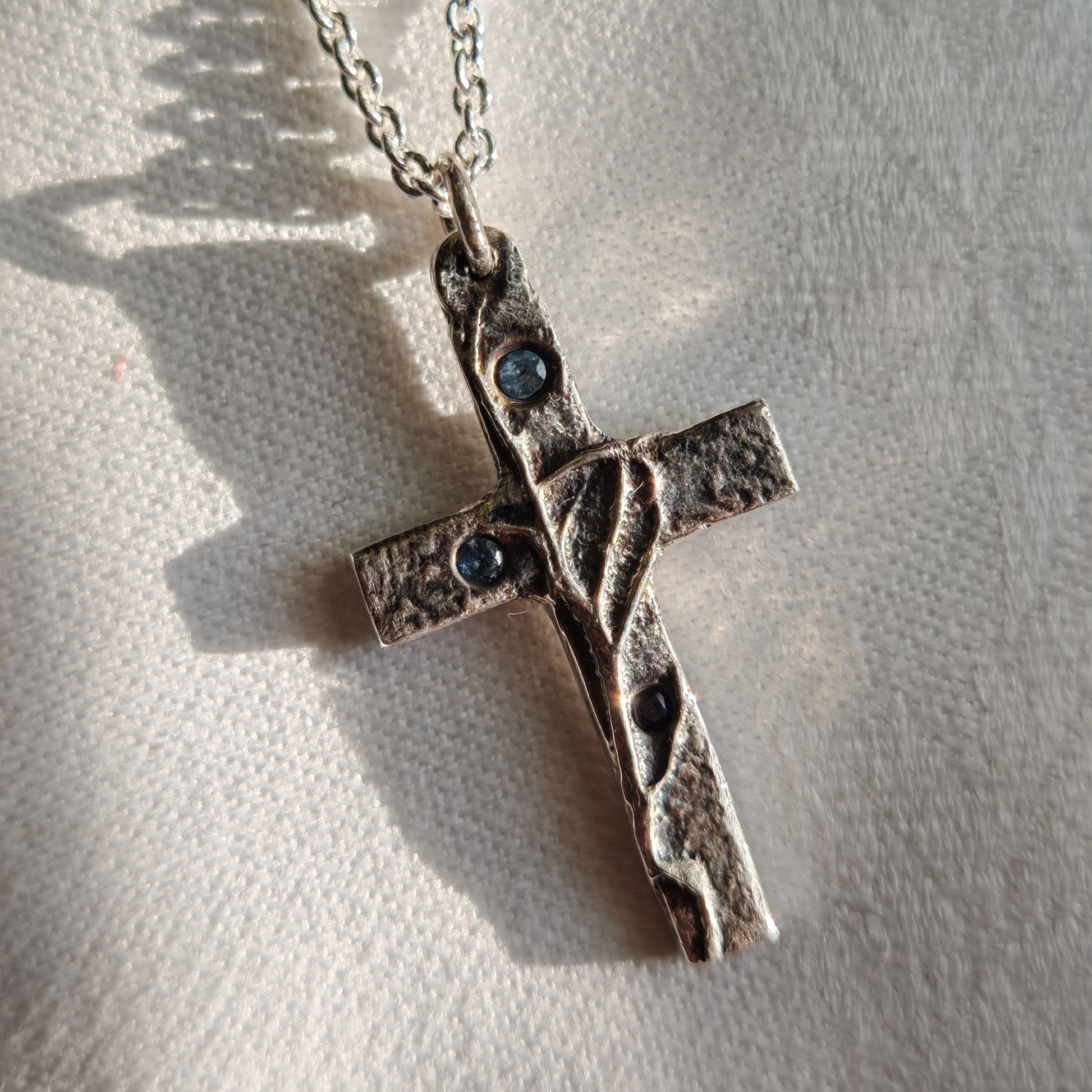 blue sapphires in cross pendant