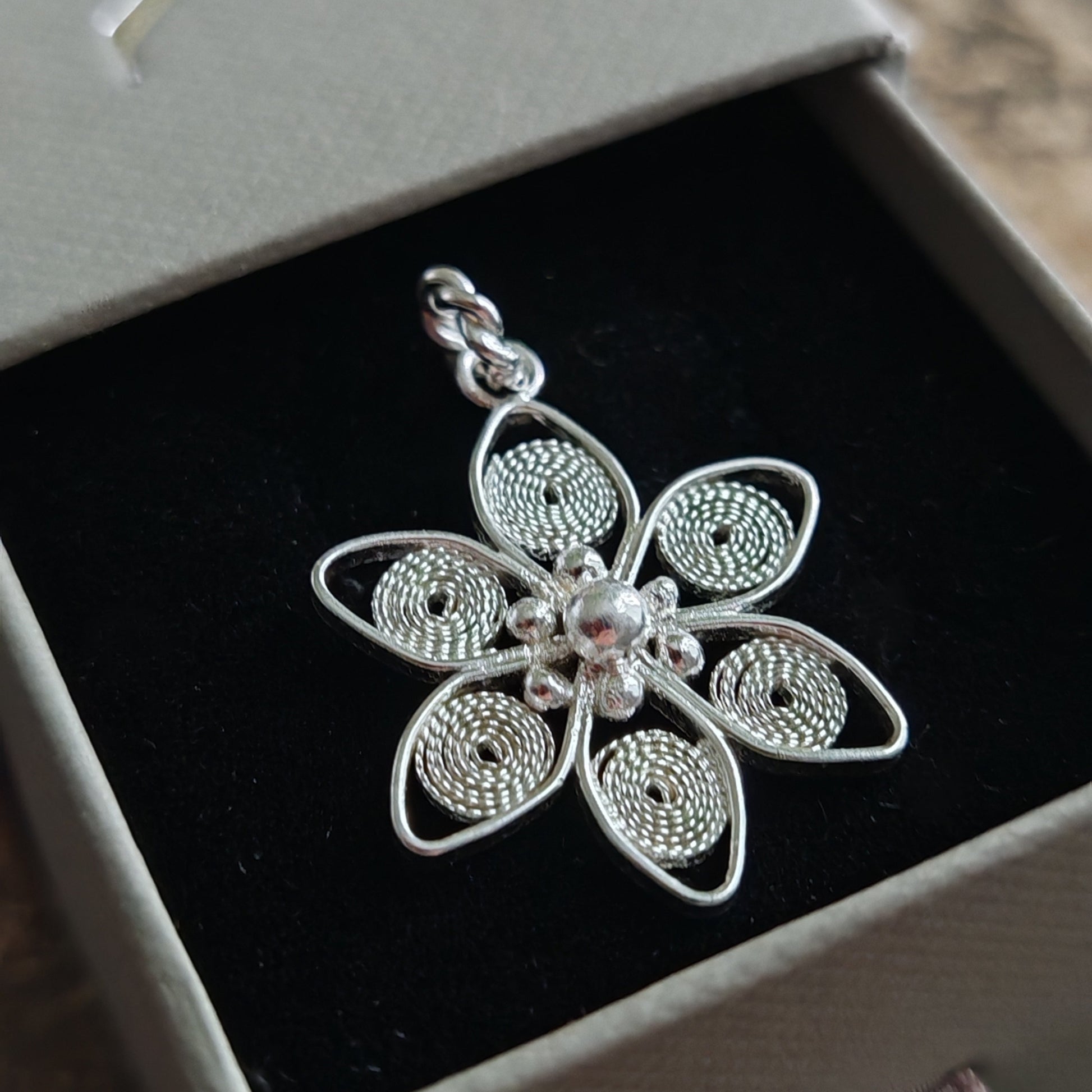 filigree white anemone pendant in a jewellery box