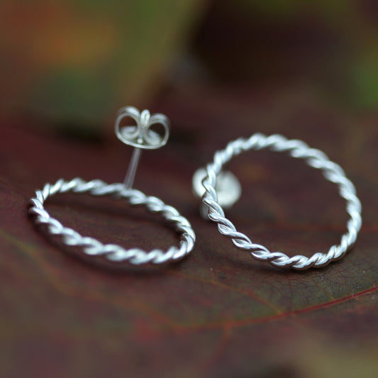 silver filigree earrings on leaf