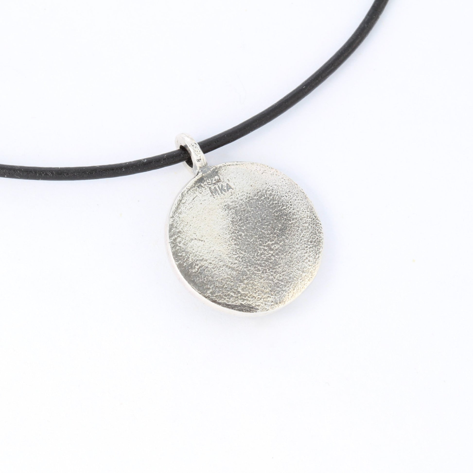 horse silver pendant with rough sapphire back