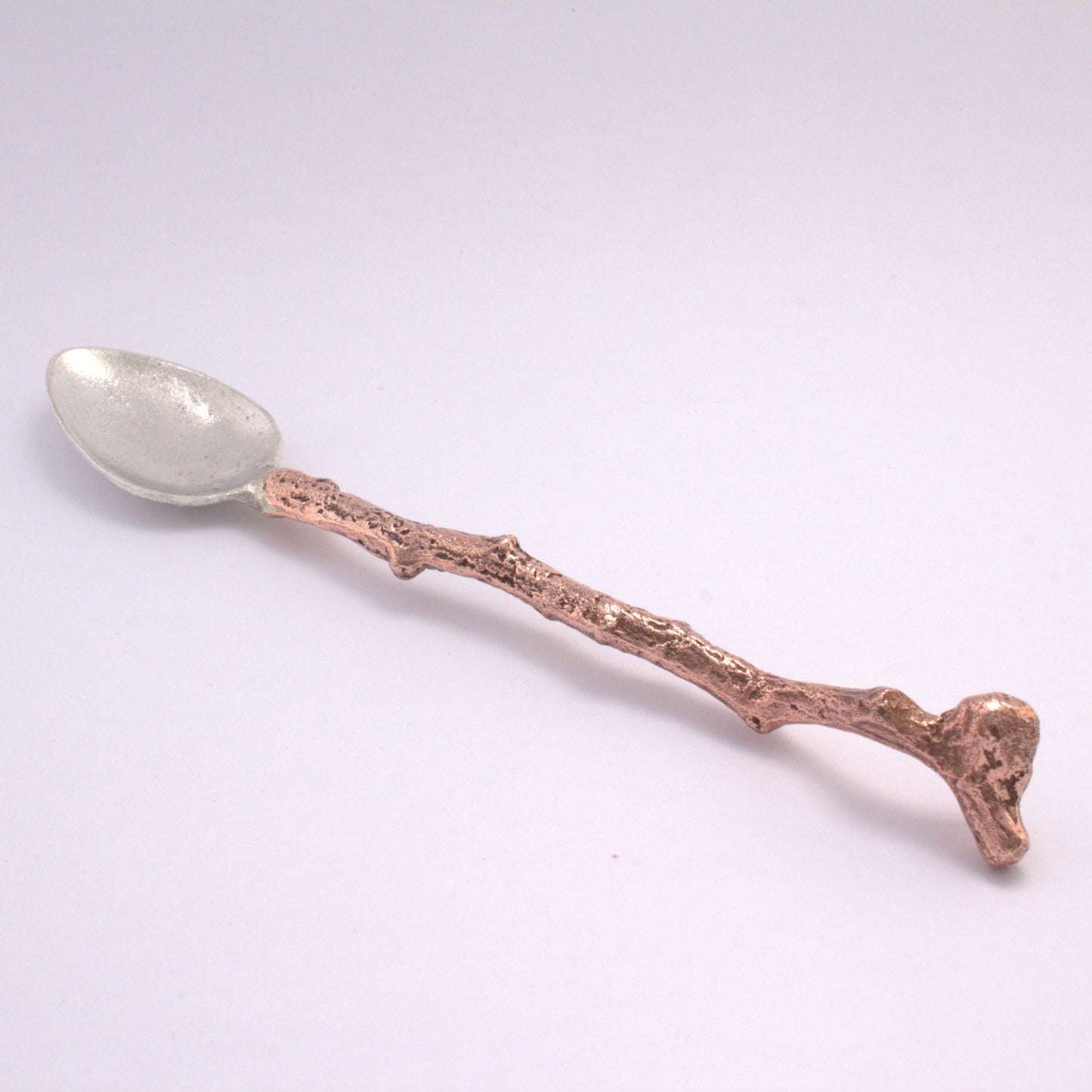 silver spoon with stick copper handle