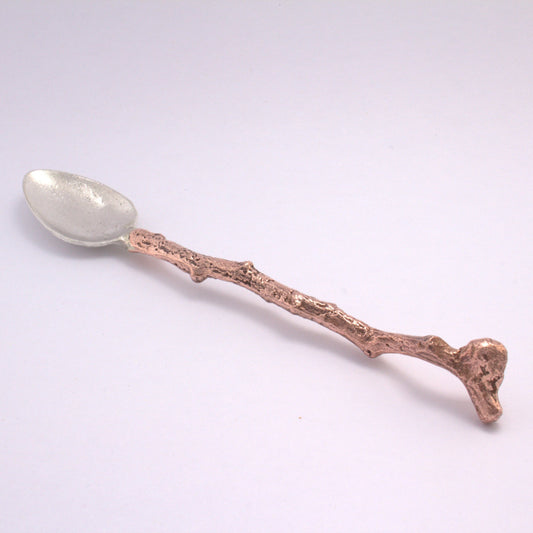 silver spoon with stick copper handle