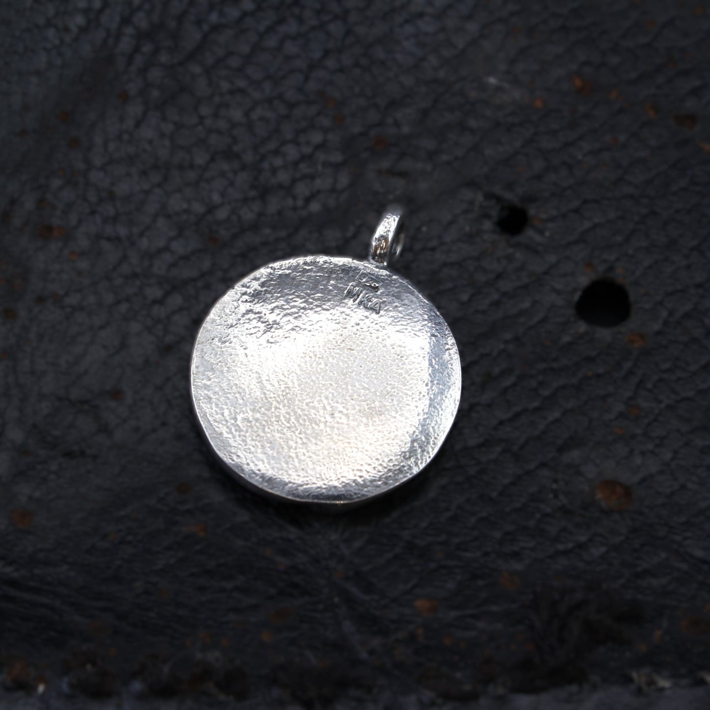 horse silver pendant with rough sapphire back on leather