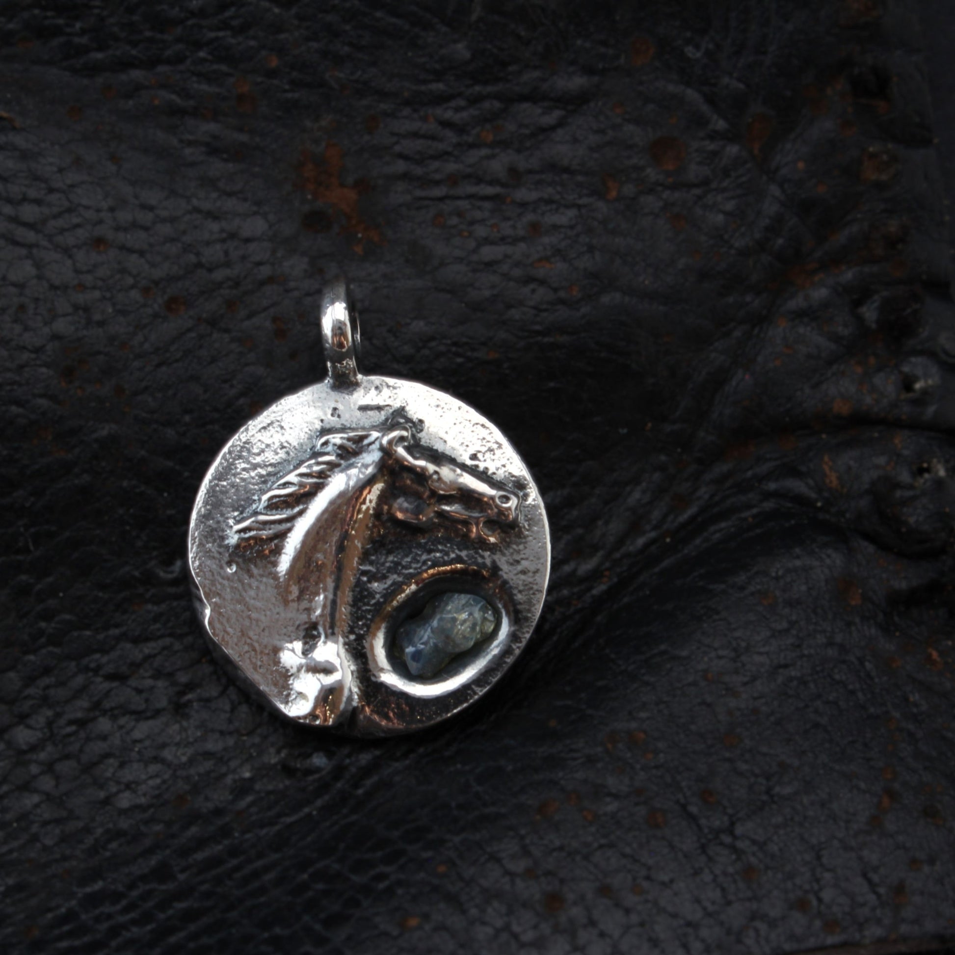 horse silver pendant with rough sapphire front on leather